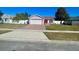 Pink house with a brick driveway and white fence at 1273 Tyler Lake Cir, Orlando, FL 32839