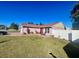 View of the home's side, showcasing a patio and lawn at 1273 Tyler Lake Cir, Orlando, FL 32839