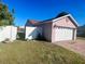 Detached two-car garage with brick-paved driveway and a well-maintained lawn at 1273 Tyler Lake Cir, Orlando, FL 32839