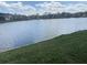 Scenic view of the community pond, perfect for enjoying waterfront living with neighborhood homes in the background at 144 Links Terrace, Daytona Beach, FL 32124