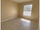 Bright bedroom with tile floors and a large window at 1608 Long Ridge Ct # 274, Orlando, FL 32807