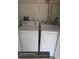 This laundry room features a side-by-side washer and dryer and overhead shelving for storage solutions at 1608 Long Ridge Ct # 274, Orlando, FL 32807