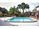 Community pool with surrounding patio and tropical landscaping at 1608 Long Ridge Ct # 274, Orlando, FL 32807