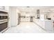 Modern white kitchen with marble floors, stainless steel appliances, and large island at 16546 7Th St, Montverde, FL 34756