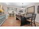 Rustic dining room with dark wood table and bench seating, adjacent to kitchen at 1860 Lake Markham Rd, Sanford, FL 32771