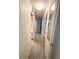 Long hallway with wall-mounted mirrors at 188 Azalea Trl, Leesburg, FL 34748