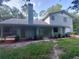 Front view of a two-story house with green exterior and landscaping at 253 N Blue Lake Ave, Deland, FL 32724