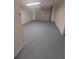 Attached garage featuring a freshly painted floor at 253 N Blue Lake Ave, Deland, FL 32724