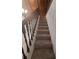 Carpeted staircase with wooden railing at 253 N Blue Lake Ave, Deland, FL 32724