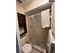 Bathroom with a shower, toilet, and a dark wooden cabinet for extra storage at 255 Sandlewood Trl # 4, Winter Park, FL 32789