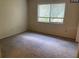 Spacious bedroom with carpeted floor and large window at 255 Sandlewood Trl # 4, Winter Park, FL 32789