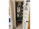 Laundry closet with HVAC unit, shelving, and fire extinguisher at 255 Sandlewood Trl # 4, Winter Park, FL 32789