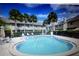 Community swimming pool and outdoor seating for residents to enjoy the sunny outdoors at 255 Sandlewood Trl # 4, Winter Park, FL 32789