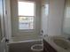 Bathroom with a bathtub, toilet, and single sink at 2802 Quiet Water Trl, Kissimmee, FL 34744