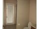 Bathroom with toilet, vanity, and exterior access at 2802 Quiet Water Trl, Kissimmee, FL 34744