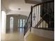 Elegant entryway with tiled floors and curved staircase at 2802 Quiet Water Trl, Kissimmee, FL 34744