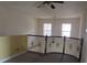 Loft area with a railing overlooking the lower level at 2802 Quiet Water Trl, Kissimmee, FL 34744