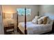 Bedroom with a wooden bed frame, nightstand, and window at 2809 Bower Rd, Winter Park, FL 32792