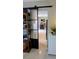 View of a home's interior, showcasing a barn door leading to another room at 2809 Bower Rd, Winter Park, FL 32792