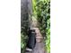 Narrow side yard with stone path and lush greenery at 2809 Bower Rd, Winter Park, FL 32792