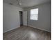 Bedroom with wood-look floors, window, and closet at 325 Garden St, Daytona Beach, FL 32114