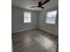 Spacious bedroom with wood-look floors and ceiling fan at 325 Garden St, Daytona Beach, FL 32114