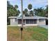 Cute ranch home with a screened porch and mature landscaping at 325 Garden St, Daytona Beach, FL 32114