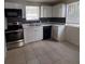 Updated kitchen with stainless steel appliances and dark tile backsplash at 325 Garden St, Daytona Beach, FL 32114