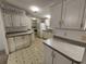 Quaint kitchen featuring white cabinets and patterned floor at 3376 Se 94Th St, Ocala, FL 34480