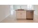 Kitchen island with stainless steel sink, granite counter, and white cabinets at 3556 Elliot Pl, Bartow, FL 33830