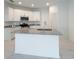 Modern kitchen features white cabinets, stainless steel appliances, and a granite island at 3556 Elliot Pl, Bartow, FL 33830