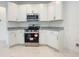 Modern kitchen features white cabinets, stainless steel appliances, and granite countertops at 3556 Elliot Pl, Bartow, FL 33830