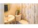 Clean bathroom with a toilet, sink, and shower at 4055 Beacon Ridge Way, Clermont, FL 34711