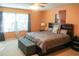 Spacious Primary bedroom with large bed and window at 4055 Beacon Ridge Way, Clermont, FL 34711