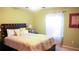 Bedroom with full-size bed and window at 4055 Beacon Ridge Way, Clermont, FL 34711