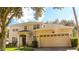 Two-story house with a large garage and manicured lawn at 4055 Beacon Ridge Way, Clermont, FL 34711