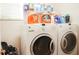 Laundry room with washer, dryer, and ample storage at 4055 Beacon Ridge Way, Clermont, FL 34711