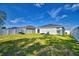 Backyard view of house with green grass and lounge chairs at 4481 Reding Way, Lakeland, FL 33813