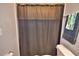 Bathroom with shower and dark gray curtain at 4481 Reding Way, Lakeland, FL 33813