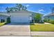 House exterior with white garage door and landscaping at 4481 Reding Way, Lakeland, FL 33813