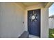 Dark blue front door with a welcome wreath at 4481 Reding Way, Lakeland, FL 33813