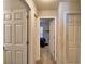 Hallway with doors to bedrooms and carpet at 4481 Reding Way, Lakeland, FL 33813