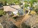 Aerial view of property, showcasing the screened pool enclosure and lush surrounding landscape at 766 Bryson Loop, Lakeland, FL 33809