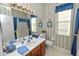 Charming bathroom with blue accents, vanity, and patterned wallpaper, creating a cozy atmosphere at 766 Bryson Loop, Lakeland, FL 33809