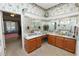 Bathroom with dual sink vanity, marble countertops, framed mirrors and floral wallpaper at 766 Bryson Loop, Lakeland, FL 33809