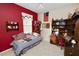 Eclectic bedroom with bold red walls, a single bed, and Americana-themed decor, with a cozy feel at 766 Bryson Loop, Lakeland, FL 33809