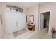 Inviting entryway with white double doors, transom window, and decorative accents over a console table at 766 Bryson Loop, Lakeland, FL 33809