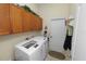 Functional laundry room with washer, dryer, and ample cabinet space for storage at 766 Bryson Loop, Lakeland, FL 33809