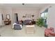 Comfortable living room with floral sofas, matching chairs, and a large window with neutral color palette at 766 Bryson Loop, Lakeland, FL 33809