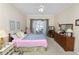 Bright main bedroom with a queen bed, wood dresser, and sliding glass doors leading to the pool area at 766 Bryson Loop, Lakeland, FL 33809